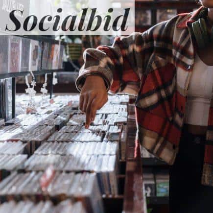 Person Wearing a Checkered Shirt in the Record store
